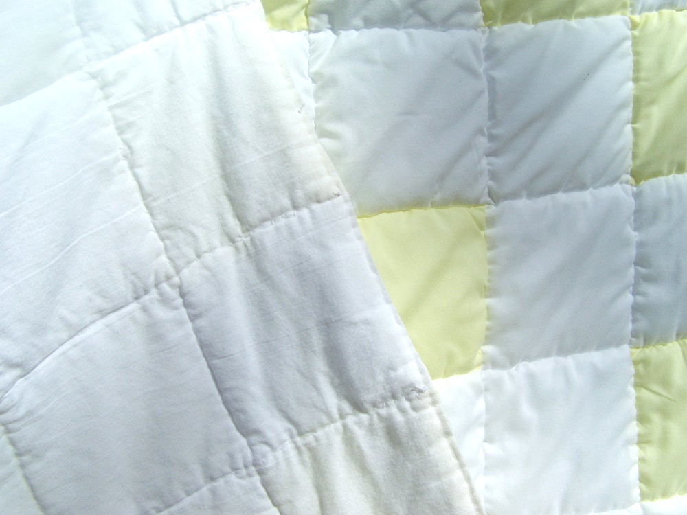 yellow and white patchwork quilt